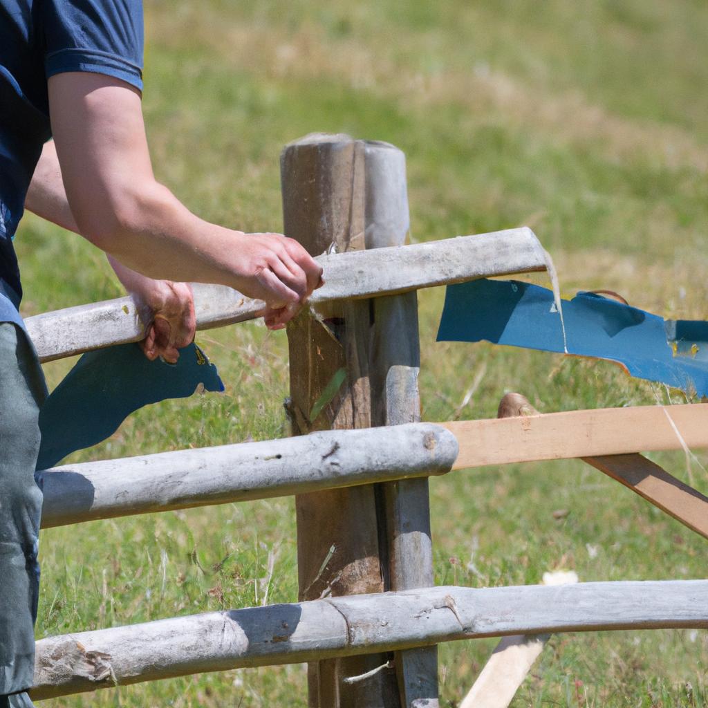 A farmer installing a sturdy wooden fence for his flock